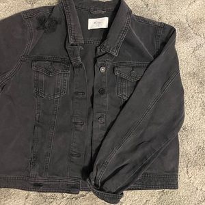 Black jean jacket, black buttons, small crop, functional pockets.